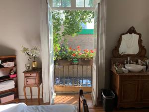 a bedroom with a door open to a balcony with flowers at Casa Turin in Mexico City +62 photos