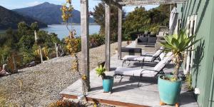a porch with chairs and a view of the water at Moana Haven B&B in Havelock