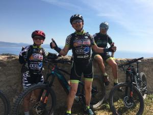 a group of three men standing next to their bikes at Bike&Boat Argentario Hotel in Porto Santo Stefano