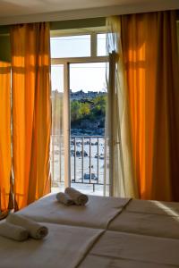 a bedroom with a bed and a large window at Four Seasons Riverside in Kutaisi