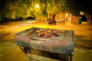 a grill with some meat on top of it at Yala Dream Park in Tissamaharama