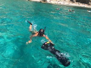 a person and a dog in the water at Bike&Boat Argentario Hotel in Porto Santo Stefano