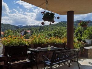 a patio with a table and chairs and flowers at Casa Din Noua in Braşov