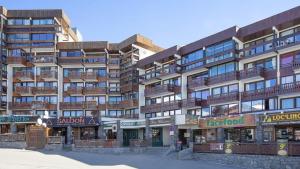 a large building with balconies on the side of it at Glaciers Cocoon in Val Thorens