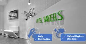 un bagno con parete bianca con un cartello sopra di Hotel Bayer's a Monaco