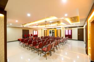 a conference room with red chairs in the middle at Shri Subham Residency in Srīrangam