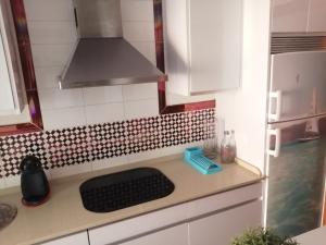 a kitchen with a counter with a stove top oven at Apartamento Zahara de los Atunes-Atlanterra in Zahara de los Atunes