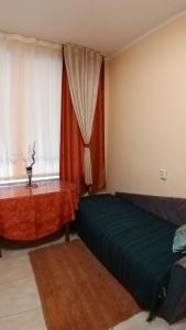 a room with a bed, a couch, and a window at Смарт-апартаменти " Lutskyj zamok" in Lutsk