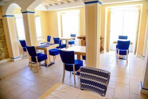 a dining room with blue chairs and tables at Chalet O Amorzinho Sintra Praia in Sintra