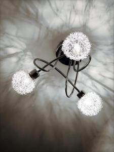 a chandelier with three lights hanging from it at Richmond Luxury flat Fabulous location in Southend-on-Sea