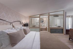 a bedroom with a white bed and a large window at Habitat Hotel in Kilkís