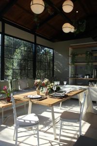 a dining table and chairs in a living room at Elies 33 Bio Retreat in Afitos