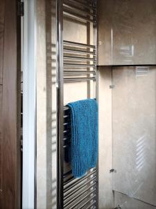 a bathroom with a blue towel on a towel rack at Richmond Luxury flat Fabulous location in Southend-on-Sea