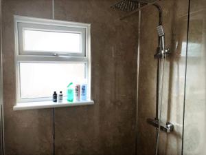 a bathroom with a window and a shower at Richmond Luxury flat Fabulous location in Southend-on-Sea