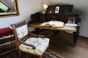 a desk with a chair and an open book at Baderhaus in Bruck an der Mur