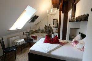 a bedroom with a bed with red pillows on it at Baderhaus in Bruck an der Mur