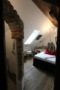 a bedroom with a bed and a brick wall at Baderhaus in Bruck an der Mur