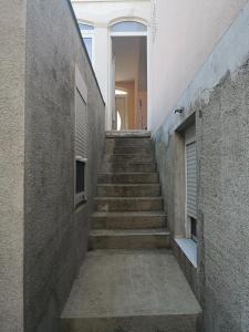 a hallway with stairs leading up to a staircase at Apartments Kresic in Hvar