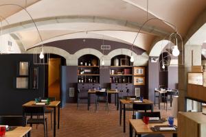 a restaurant with tables and chairs in a room at Castello Di Monterone in Perugia