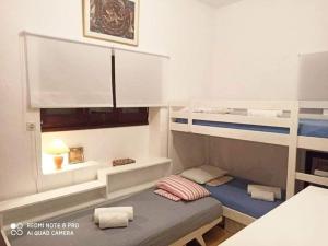 a small room with a bunk bed and a window at Beach House in Zagora