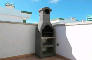 a pizza oven on the side of a building at Vistagolf Maspalomas in Maspalomas