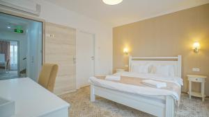 a hotel room with a large bed and two tables at Monarch House in Braşov