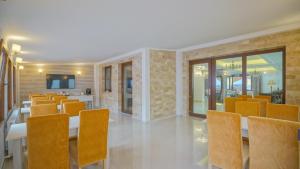 a dining room with orange chairs and a table at Monarch House in Braşov