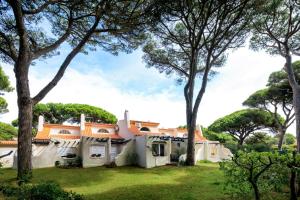 an exterior view of a house with trees at Charming Villa Golf & Beach in Cascais