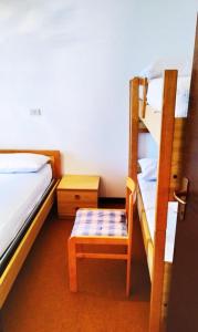 a room with two bunk beds and a chair at La Veranda sul Matese - Appartamento a Campitello Matese in San Massimo