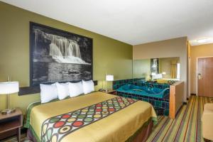 a hotel room with a bed and a bathroom at Super 8 by Wyndham Goshen in Goshen