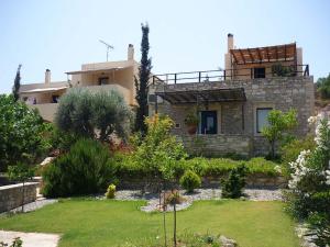 a house with a garden in front of it at Sivas Apartments-Studios,Sigelakis with very nice view in Sívas