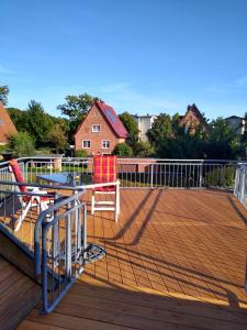 a deck with a table and chairs on it at Münsterblick in Bad Doberan