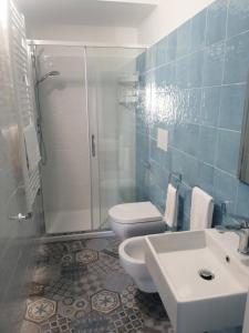 a bathroom with a toilet and a shower and a sink at Locanda B&B Dandana in Orgosolo