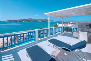 a balcony with chairs and a view of the ocean at Hotel Dolphin St Giorgio in Agios Georgios