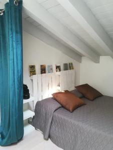 a bedroom with a bed and a blue curtain at Relais Officina del Tempo in Paese