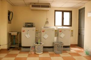 a room with three refrigerators in a room at S.K. Residence in Bangkok