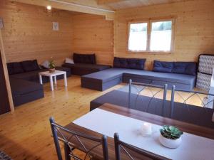 a living room with blue couches and a table at Leśnisko in Niegowa