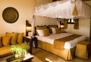 a bedroom with a bed and a couch at Breezes Beach Club and Spa in Bwejuu