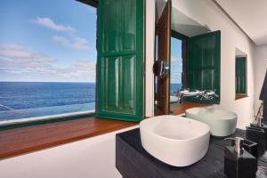 a bathroom with a sink and a window with the ocean at Lighthouse on La Palma Island in Barlovento