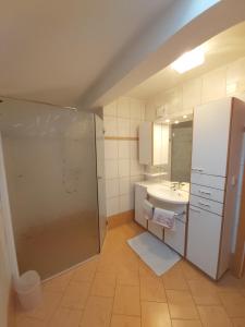 a bathroom with a shower and a sink and a mirror at Apartment Ladinger in Radstadt +14 photos