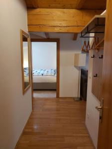 einen Flur mit einem Spiegel und einem Bett in einem Zimmer in der Unterkunft Apartment Ladinger in Radstadt