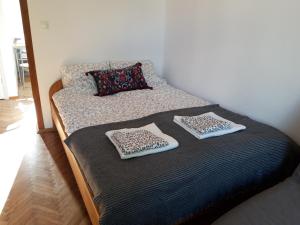 a bed with two pillows on it in a room at White Apartment House in Bielsko-Biała