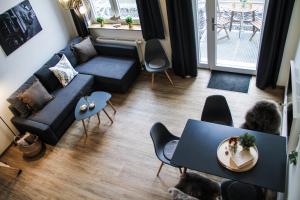 a living room with a couch and a table at Alte Käserei Ferienwohnungen in Flensburg
