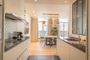 a kitchen with a table and a dining room at Spacious modern appartments in the heart of Brussels in Brussels