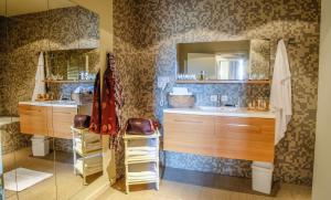 a bathroom with a sink and a mirror at La Merveilleuse by Infiniti Resorts in Dinant