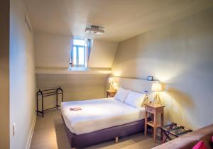 Postel nebo postele na pokoji v ubytování La Merveilleuse by Infiniti hôtel