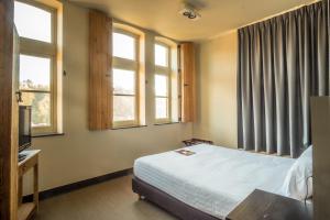 Postel nebo postele na pokoji v ubytování La Merveilleuse by Infiniti hôtel
