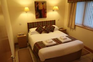 a hotel room with a bed with towels on it at Corunna Cottage in Inverness