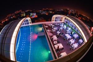 a view of a pool on a cruise ship at night at AZ Hôtels Vieux Kouba in Alger