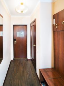 a hallway with two wooden doors and wooden floors at Posadskiy Hotel in Sergiyev Posad